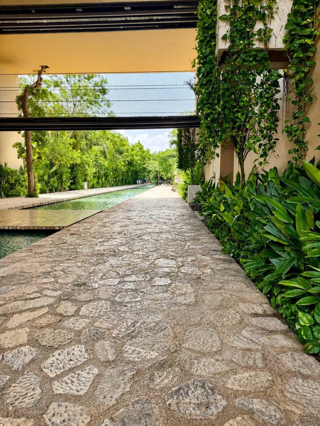The stone walkway along the lobby water channel at Hotel Xcaret México